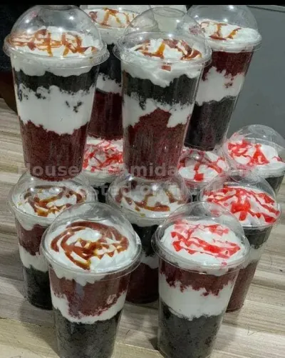 Fresh red velvet and chocolate parfaits topped with whipped cream.